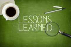 Lessons learned concept on green blackboard